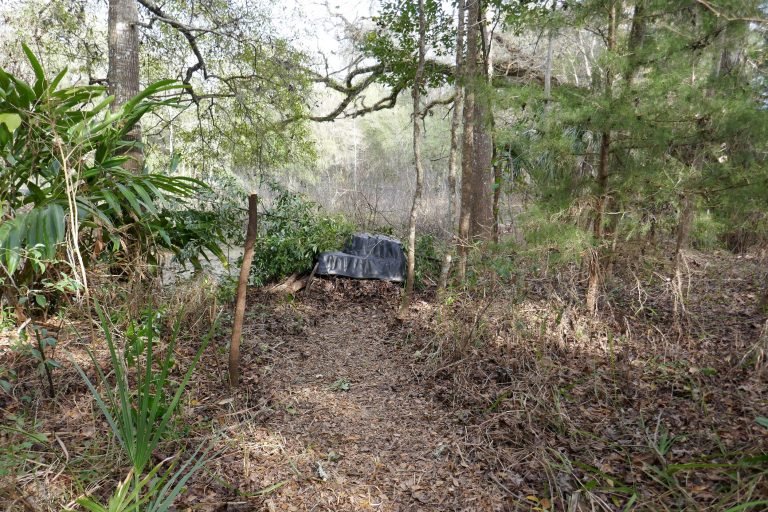 a preformed pond liner upside down to be set to use as a base for a brushpile